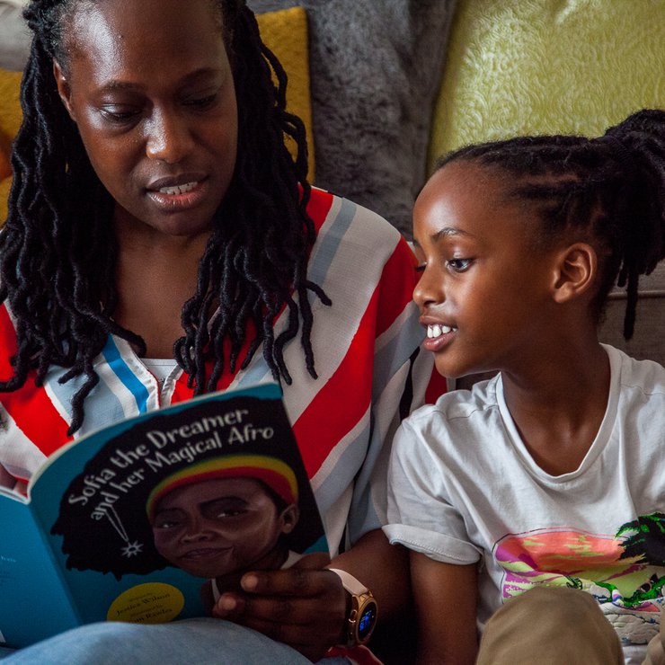 Boy reading with his parent