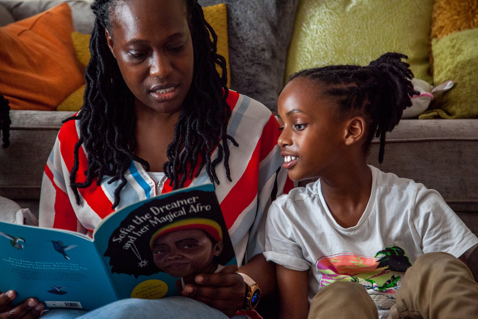 Boy reading with his parent