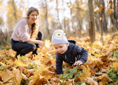 baby crawling in leaves