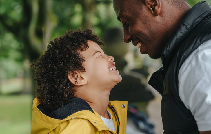 Dad and boy outside looking at each other