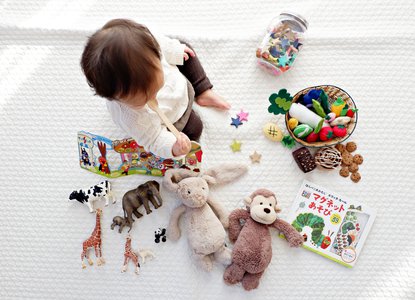 One year old playing with toys on the floor